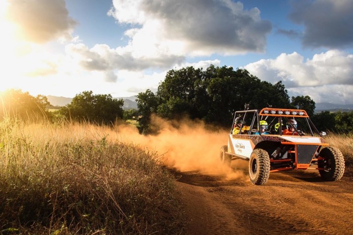 ATV riding down a dirt road